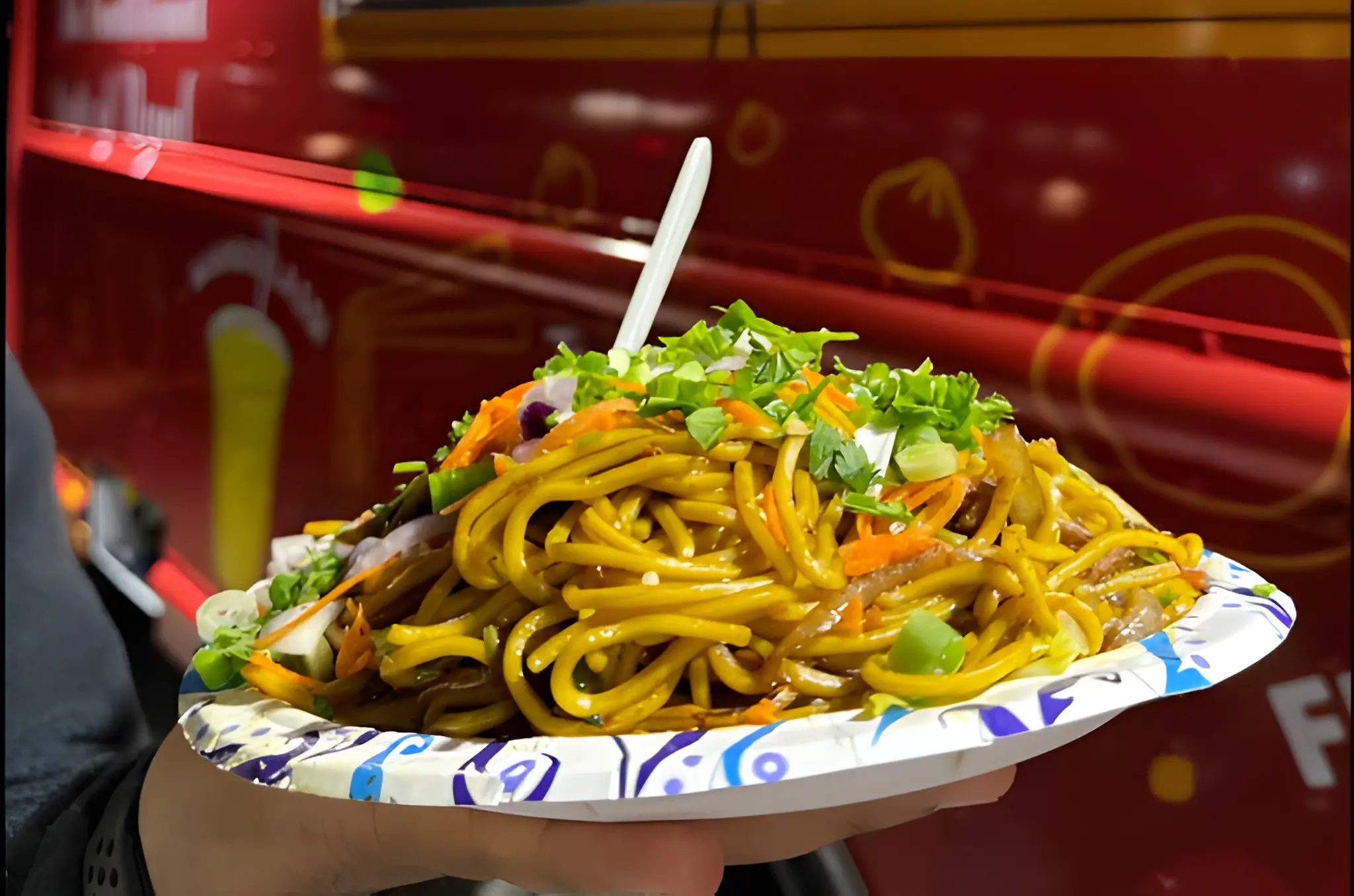 Tibet Kitchen restaurant menu board with owner at 2359 Arapahoe Ave, Boulder CO